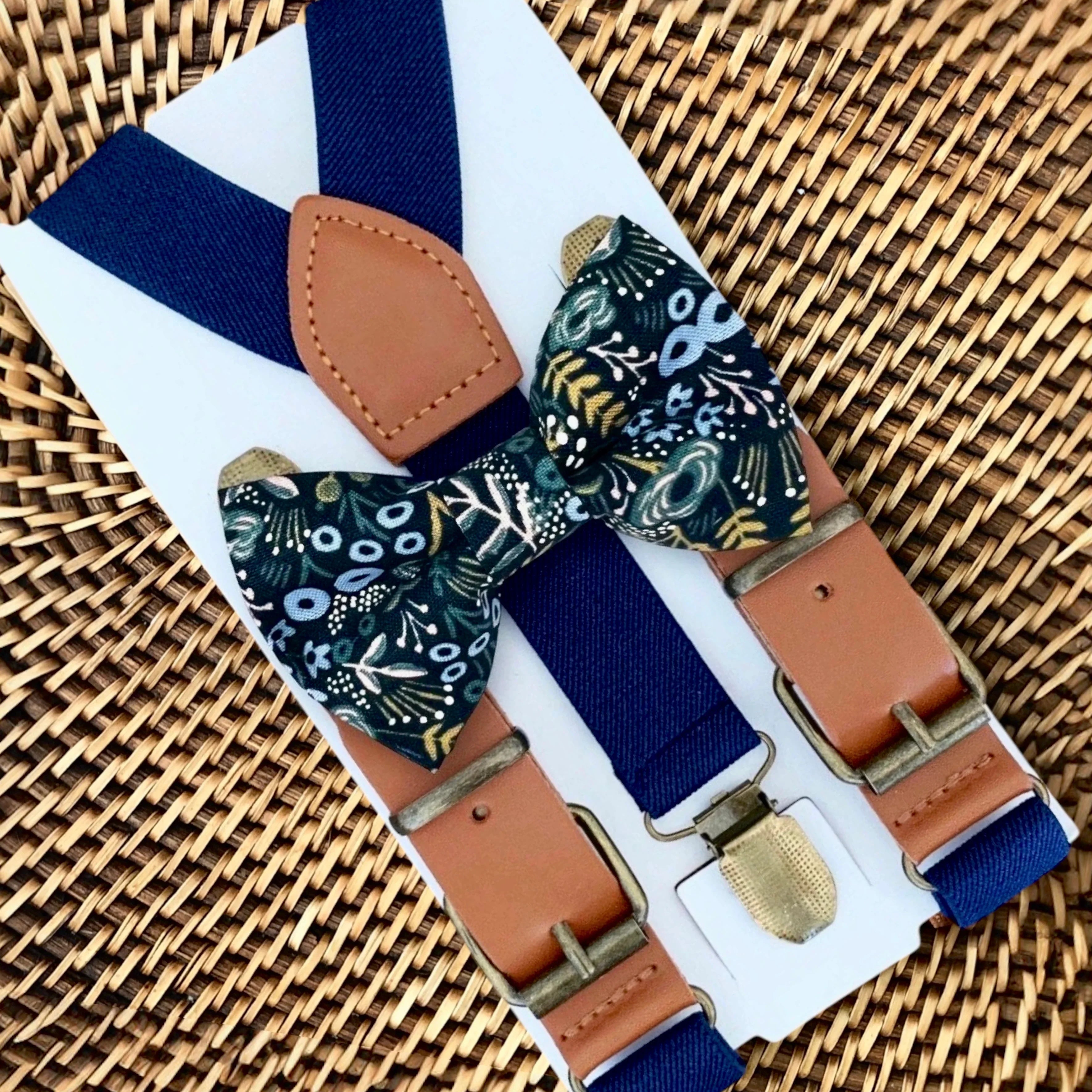Size chart for suspender and bow tie sets from The Bold Bow Tie. X-Small (6mo-4yr): 15"-23" suspenders, 3.5" bow. Small (5-9yr): 18"-33" suspenders, 3.5" bow. Medium (10-12yr): 18"-33" suspenders, 4" bow. Adult (13yr-6'5"): 30"-53" suspenders, 4.5" bow. Big & Tall (Over 6'5"): 53"+ suspenders, 4.5" bow. Instructions note to measure from the back waistband over the shoulder to the front waistband for a comfortable fit.