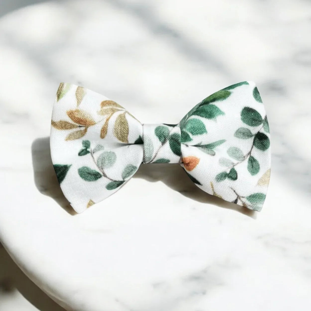 Size chart for pre-tied bow ties from The Bold Bow Tie detailing measurements across three sizes. Small is 3.5 inches wide and recommended for ages 6 months to 5 years. Medium is 4 inches wide and recommended for ages 6 to 12 years. Large is 4.5 inches wide and recommended for ages 13 years and up. Visual icons illustrate the relative sizes with horizontal arrows showing that width is measured from wingtip to wingtip. Bottom text notes that all bow ties are pre-tied and ready to add to your outfit.