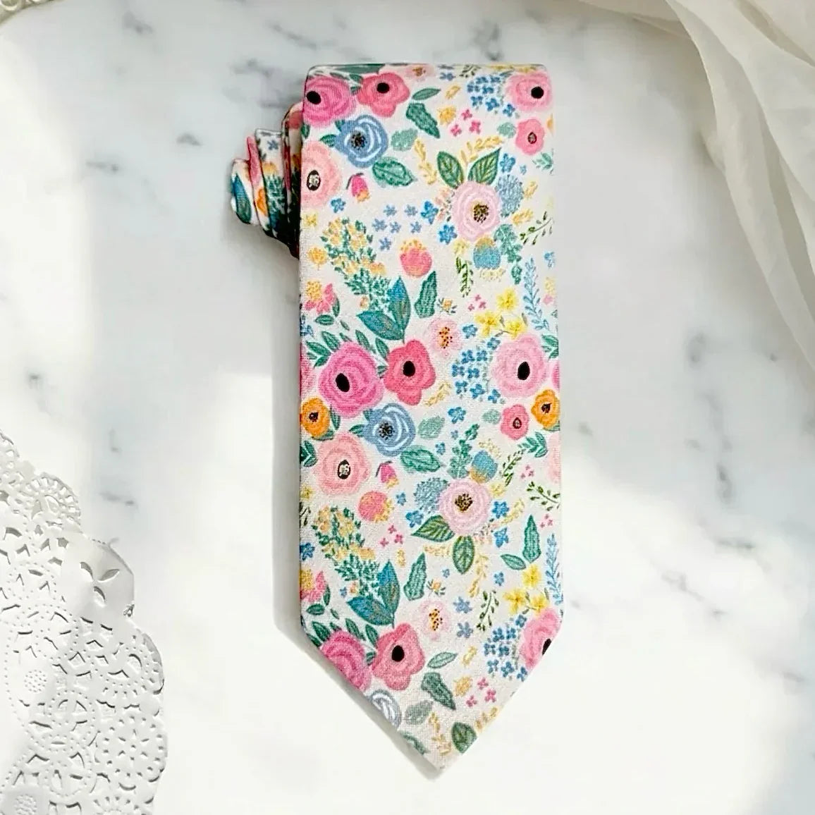 Floral mens tie on a marble surface