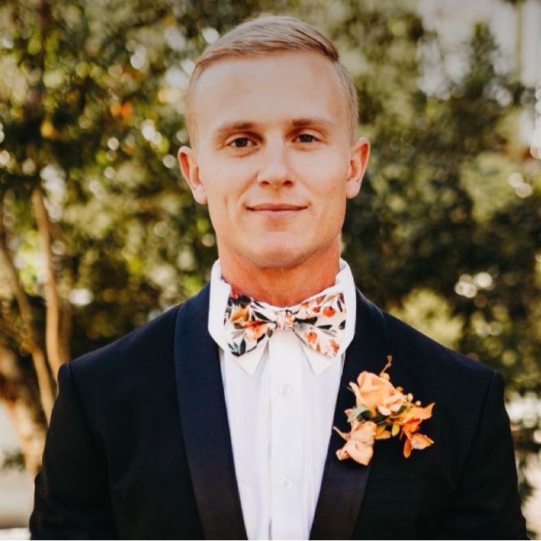 Groom wearing an ivory terracotta floral bow tie.