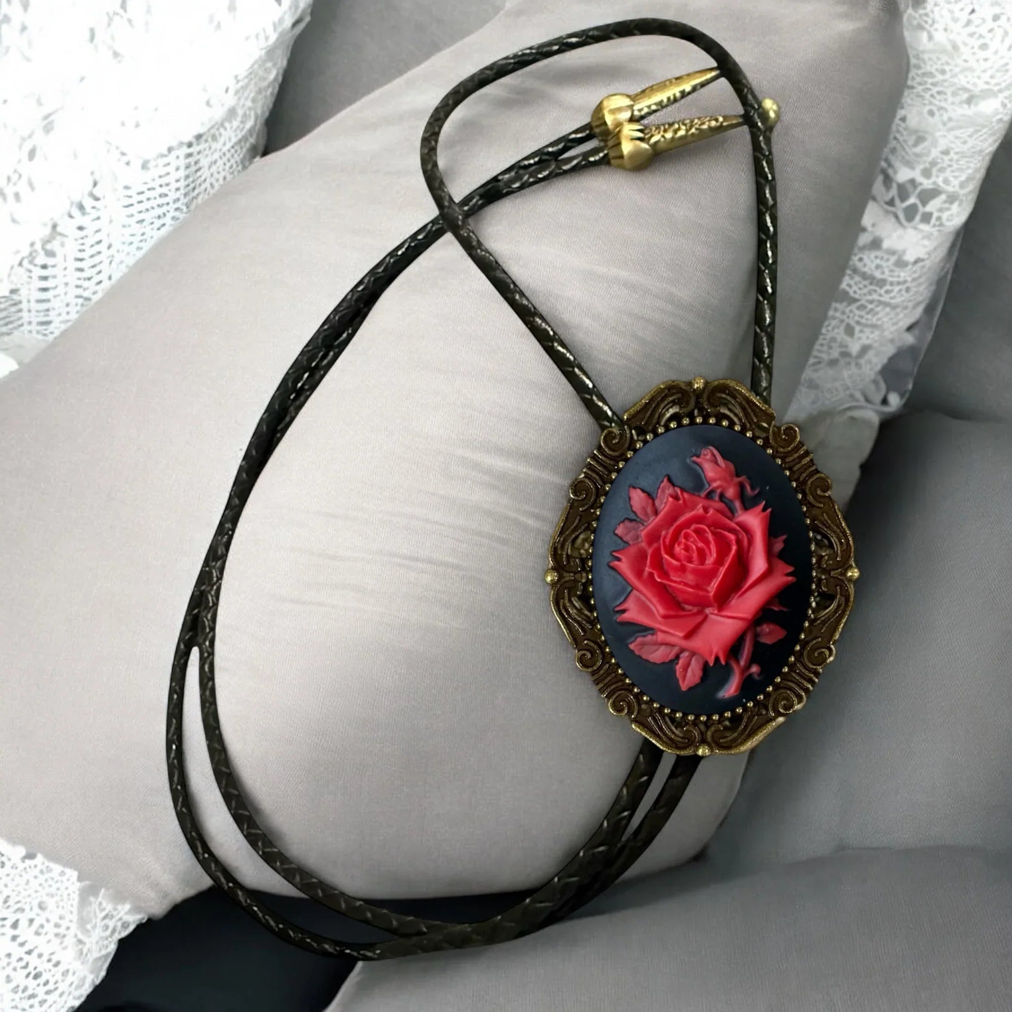 Red and black bolo tie with red rose.