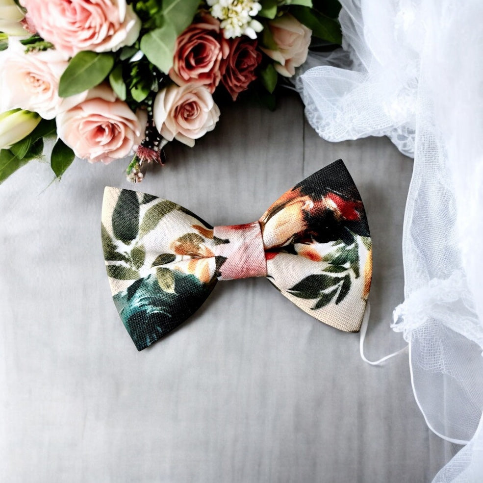 Ivory terracotta floral Bow Tie in for weddings, groomsmen and ring bearers surrounded outfits surrounded by wedding accessories.