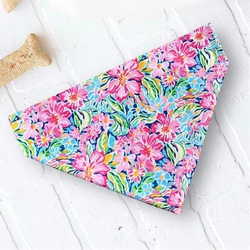 Pink floral preppy summer dog bandana with bright blossoms on a light blue background