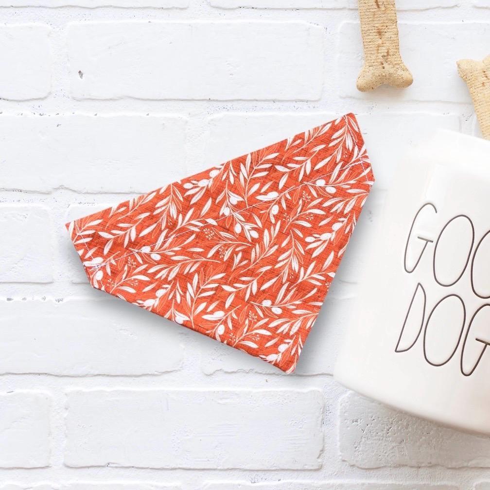 On the right, a fluffy tan dog wears a patterned bandana reading Stud Muffin with muffin graphics. On the left, pointer lines connect the image to four checkmark features: Handmade, Comfortably slides onto pet’s collar, High quality fabric, and Variety of sizes for all breeds. Bottom right text reads Makes a Great Gift!