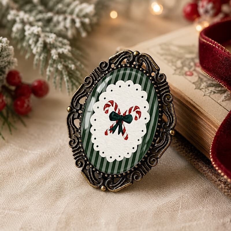 Vintage-style Christmas brooch with candy cane design, green stripes, and ornate frame, perfect for holiday outfits.