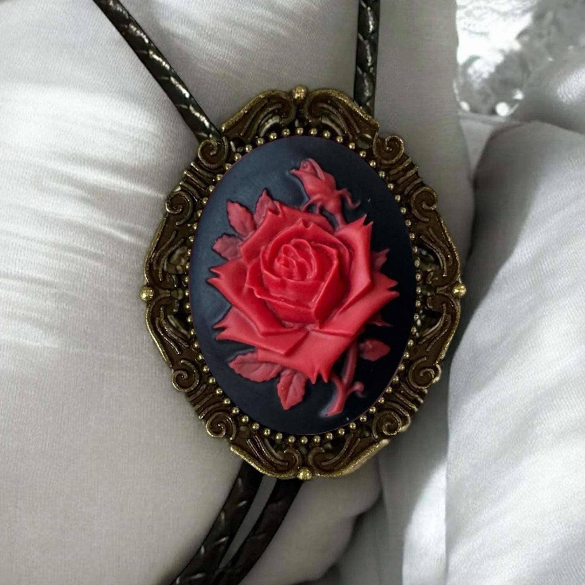 Red and Black bolo tie with leather cord.