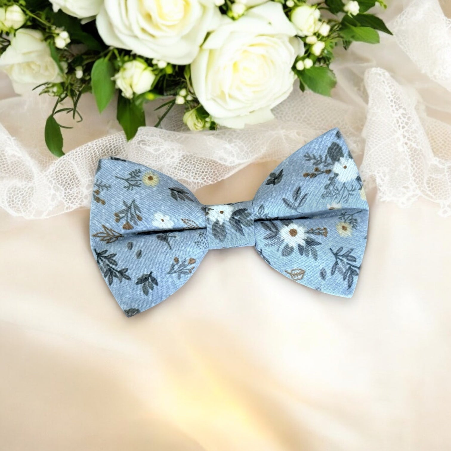 Blue Floral Bow Tie for ring bearers, groomsmen or groom against a lace background.
