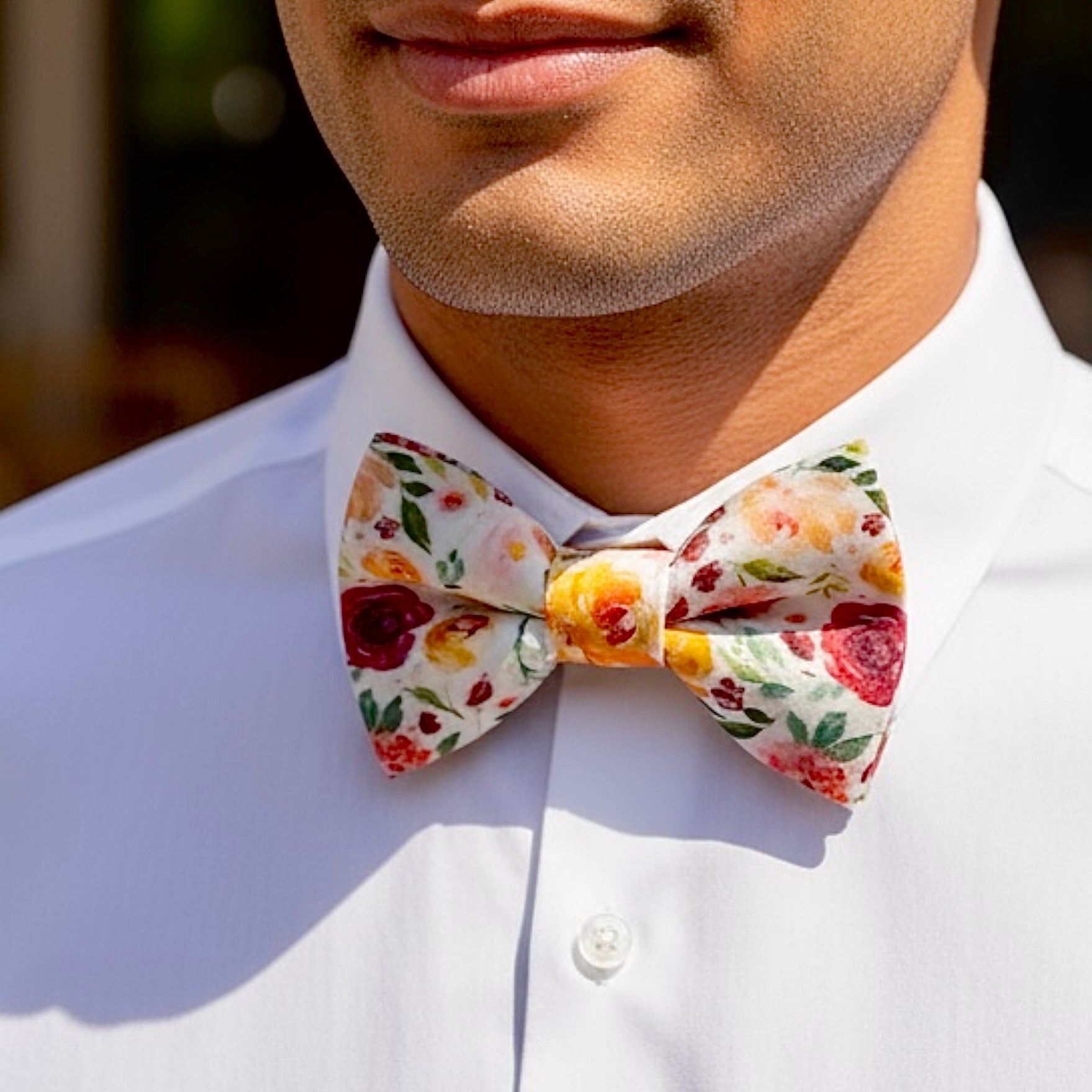 Groomsman wearing a floral bow tie for a wedding.