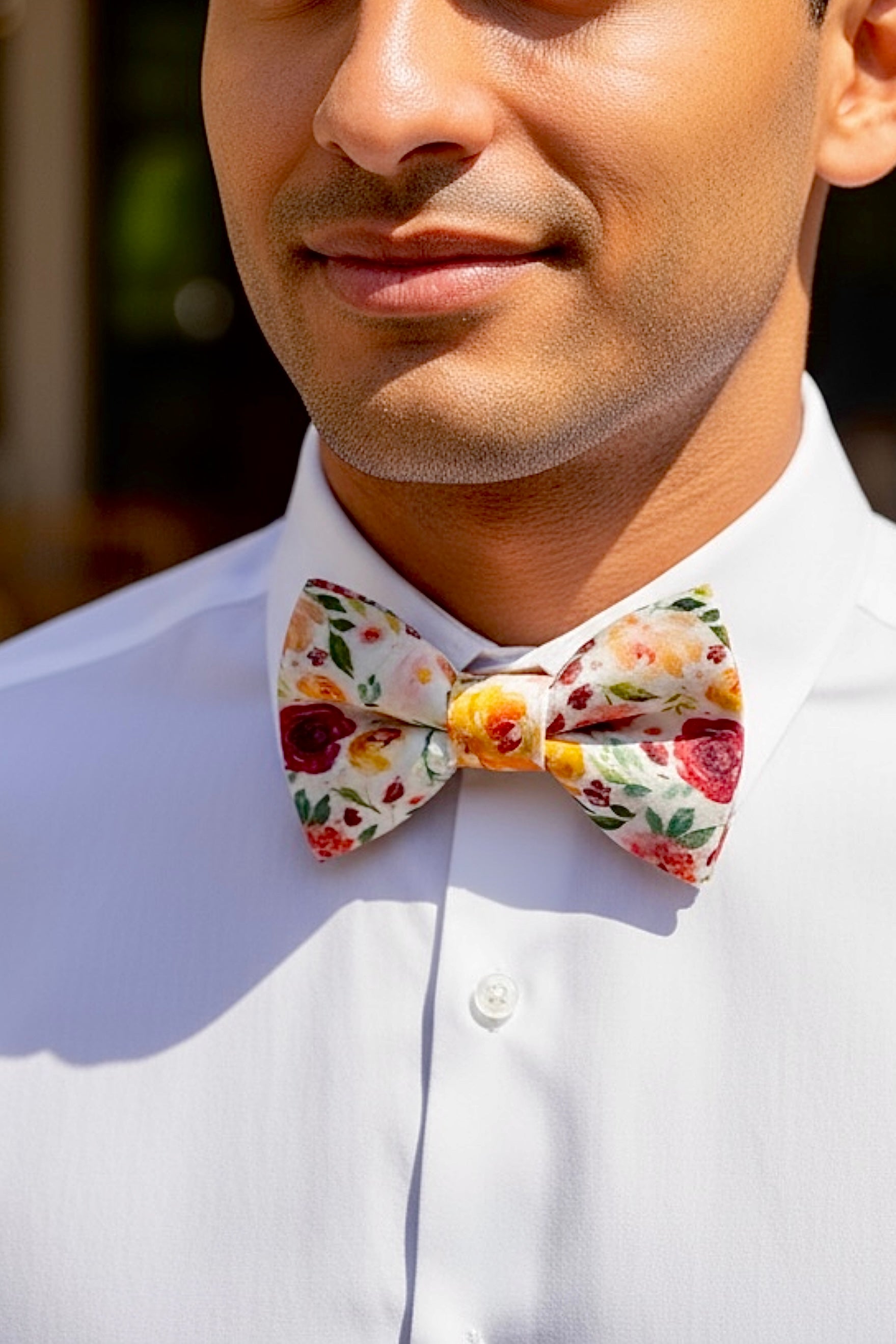 Groomsman wearing a floral bow tie for a wedding.