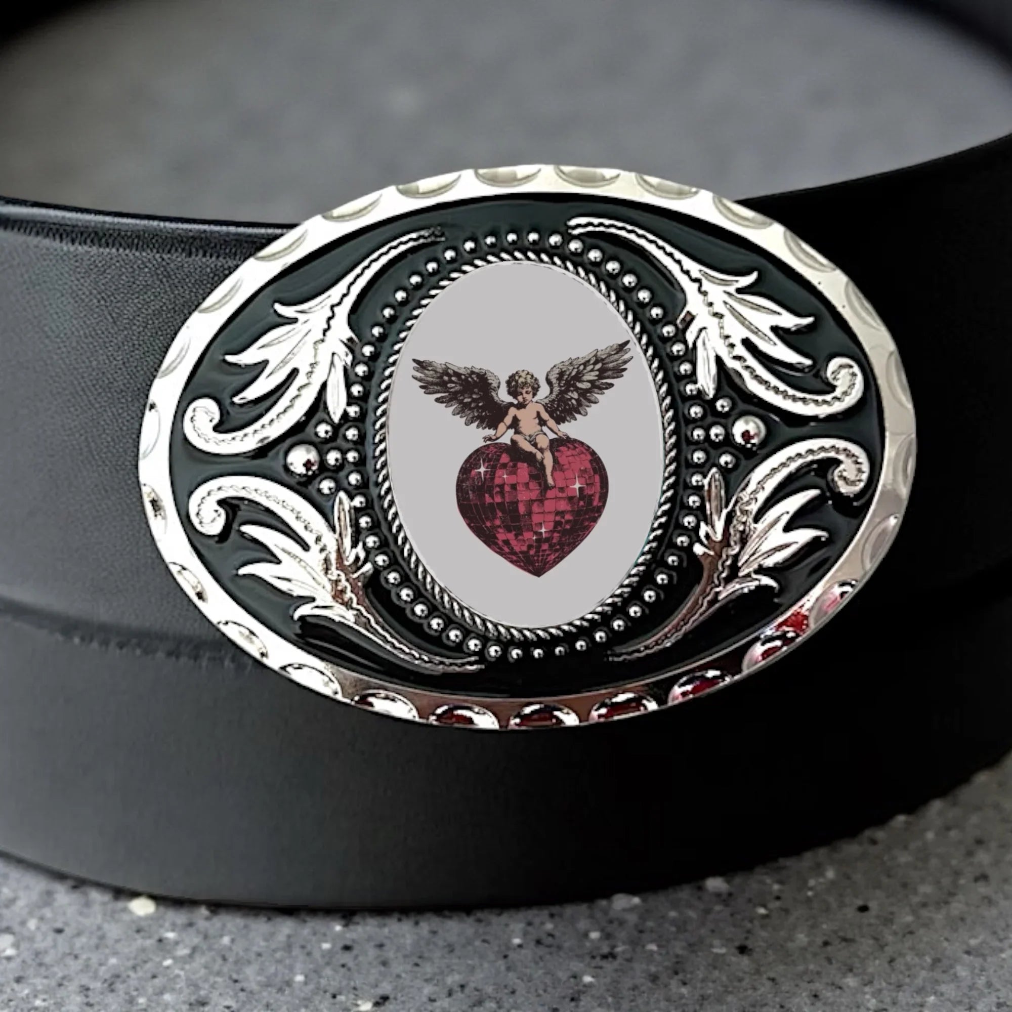Two options for belt buckles: Option 1 has a leaf pattern and option 2 has flowers on it