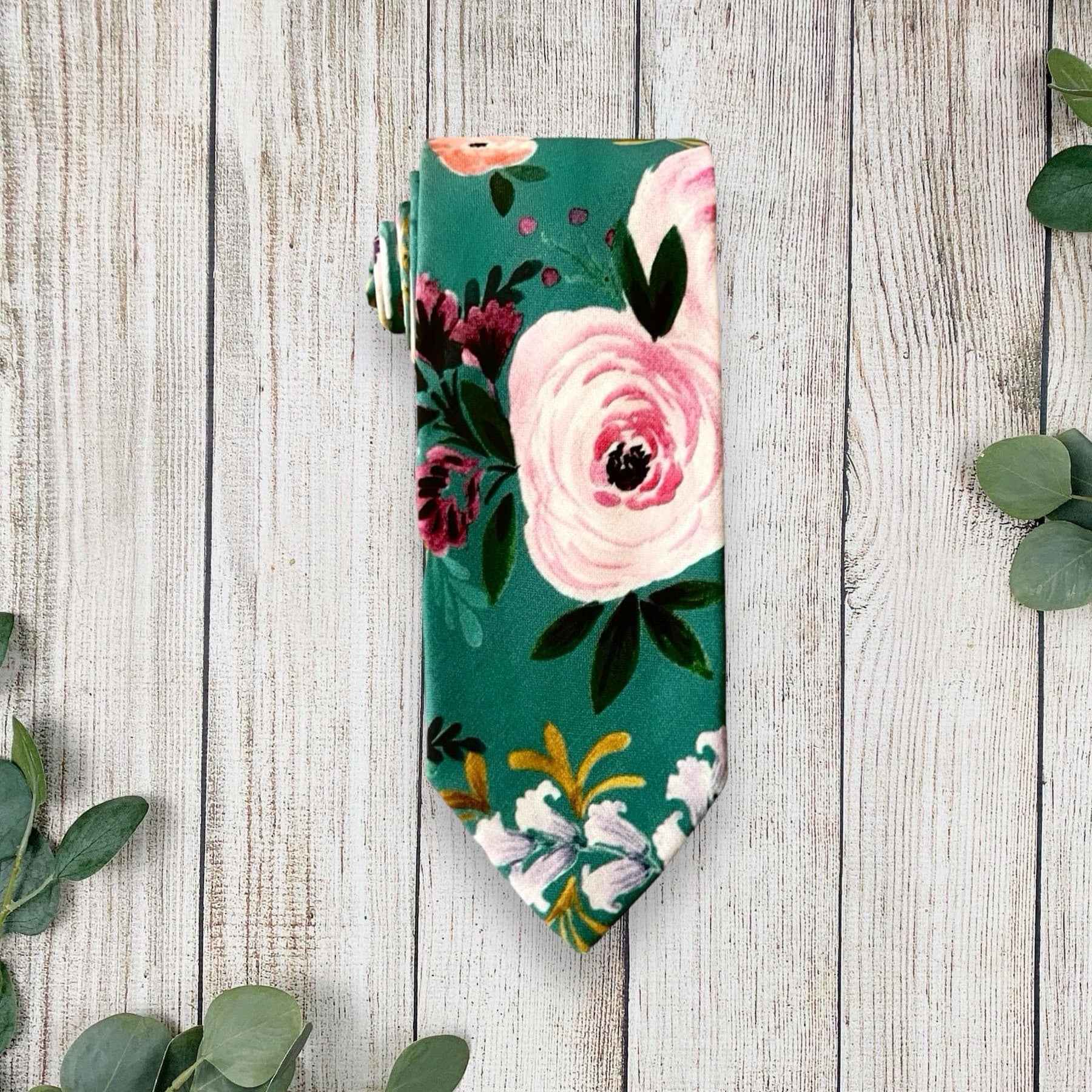 Teal floral necktie for men for wedding on a white marble counter