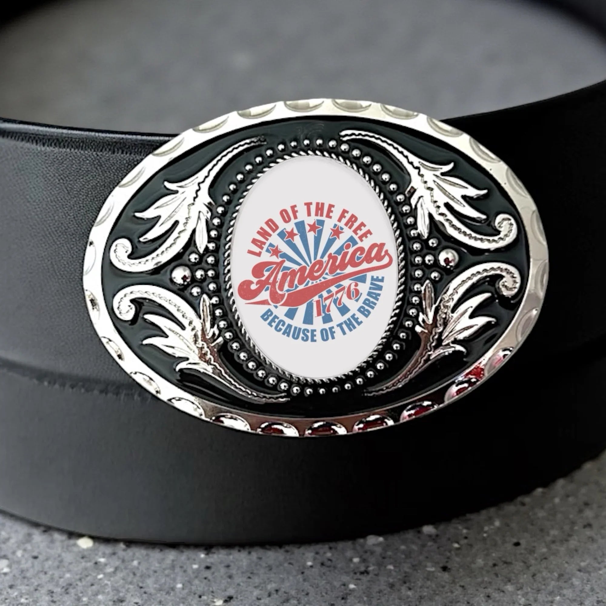 Two options for belt buckles: Option 1 has a leaf pattern and option 2 has flowers on it