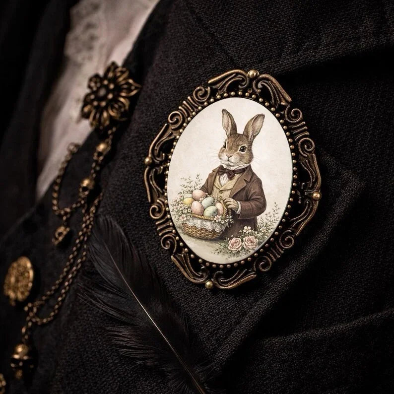 Decorative brooch with a rabbit holding Easter eggs on a dark background