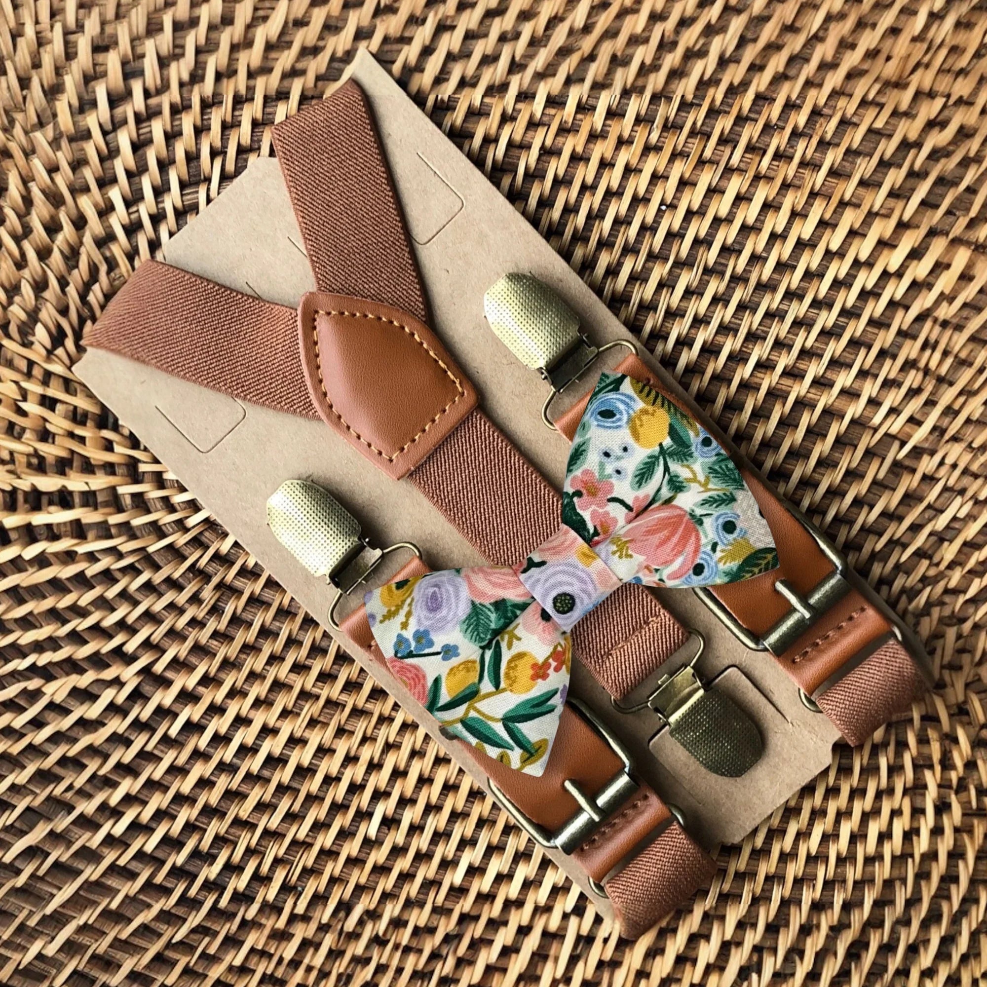Size chart for suspender and bow tie sets from The Bold Bow Tie. X-Small (6mo-4yr): 15"-23" suspenders, 3.5" bow. Small (5-9yr): 18"-33" suspenders, 3.5" bow. Medium (10-12yr): 18"-33" suspenders, 4" bow. Adult (13yr-6'5"): 30"-53" suspenders, 4.5" bow. Big & Tall (Over 6'5"): 53"+ suspenders, 4.5" bow. Instructions note to measure from the back waistband over the shoulder to the front waistband for a comfortable fit.