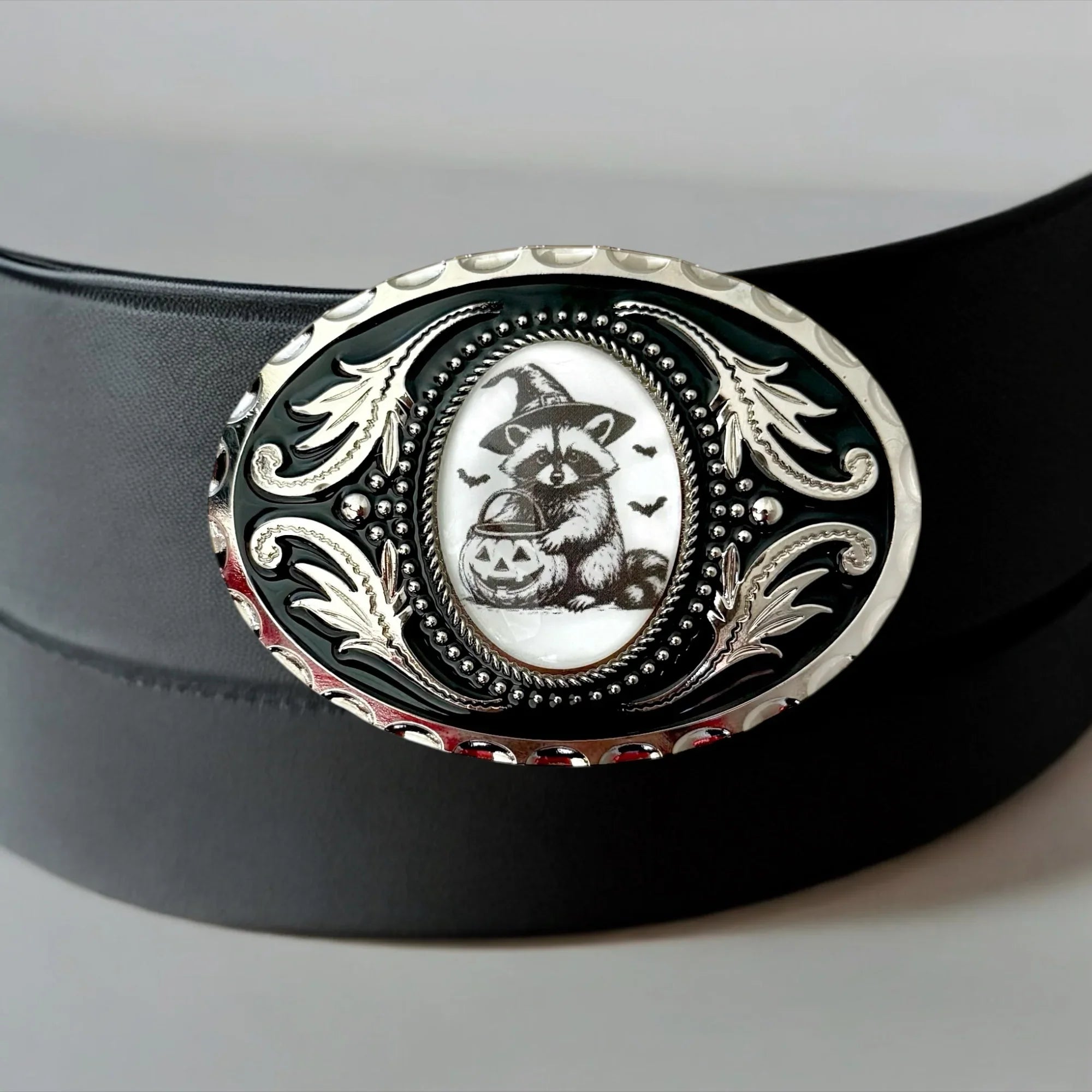 Two options for belt buckles: Option 1 has a leaf pattern and option 2 has flowers on it