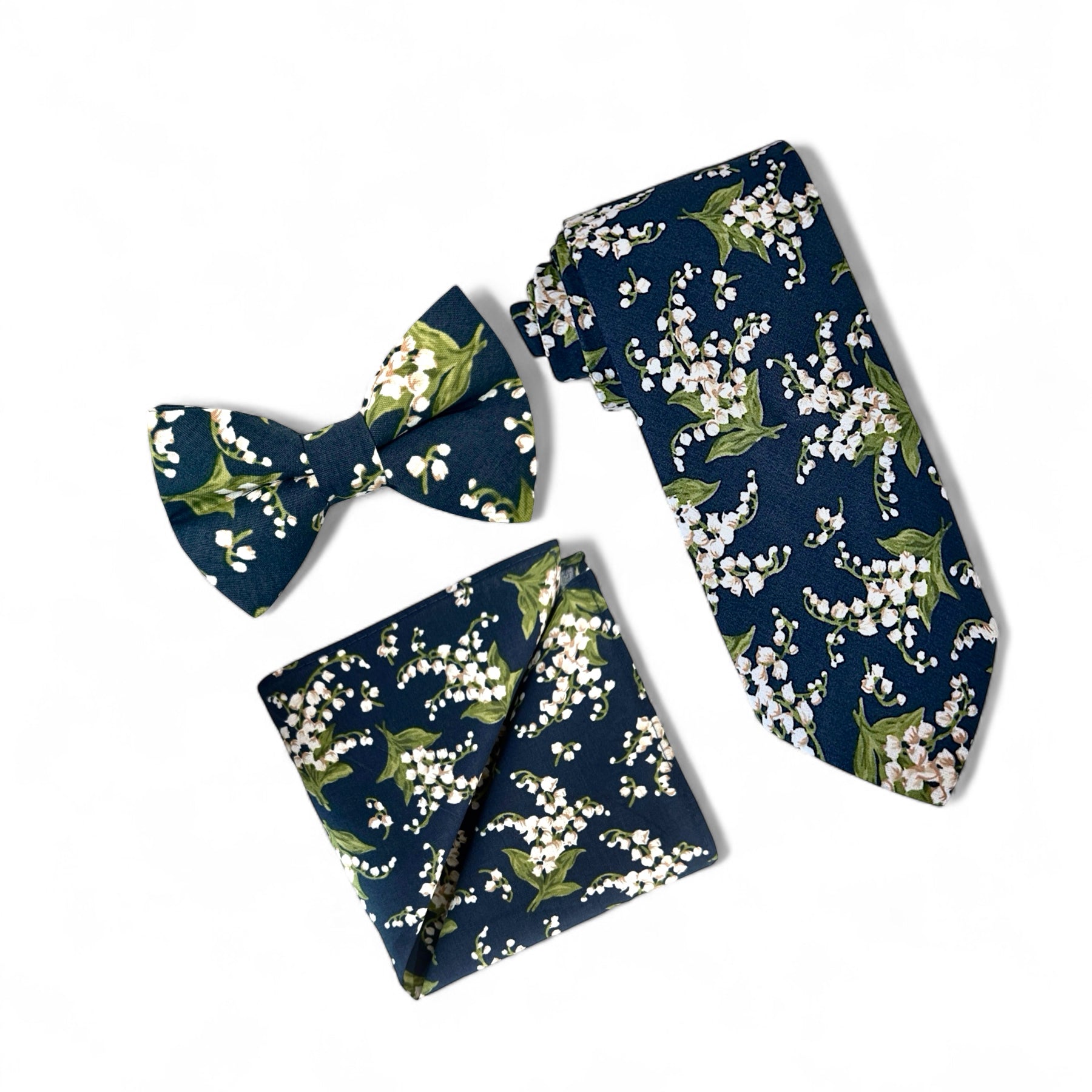 Navy blue and white floral men’s tie, bow tie and pocket square for wedding.