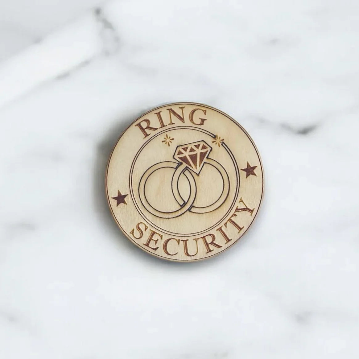 Ring bearer badge that says "Ring Security" with engraved wedding ring silhouettes, handmade in the USA.