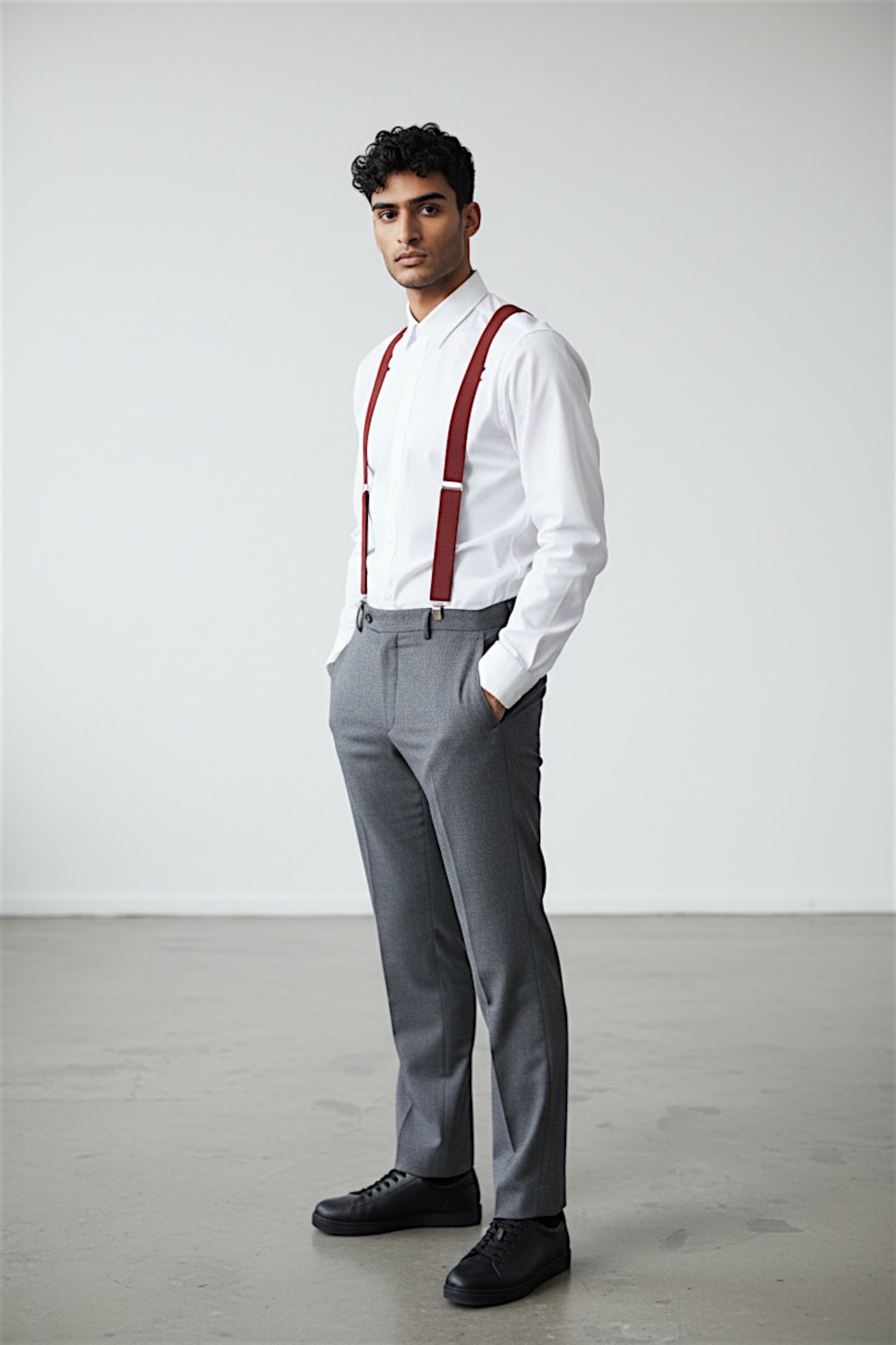 Man wearing terracotta suspenders as a groomsman in a wedding.