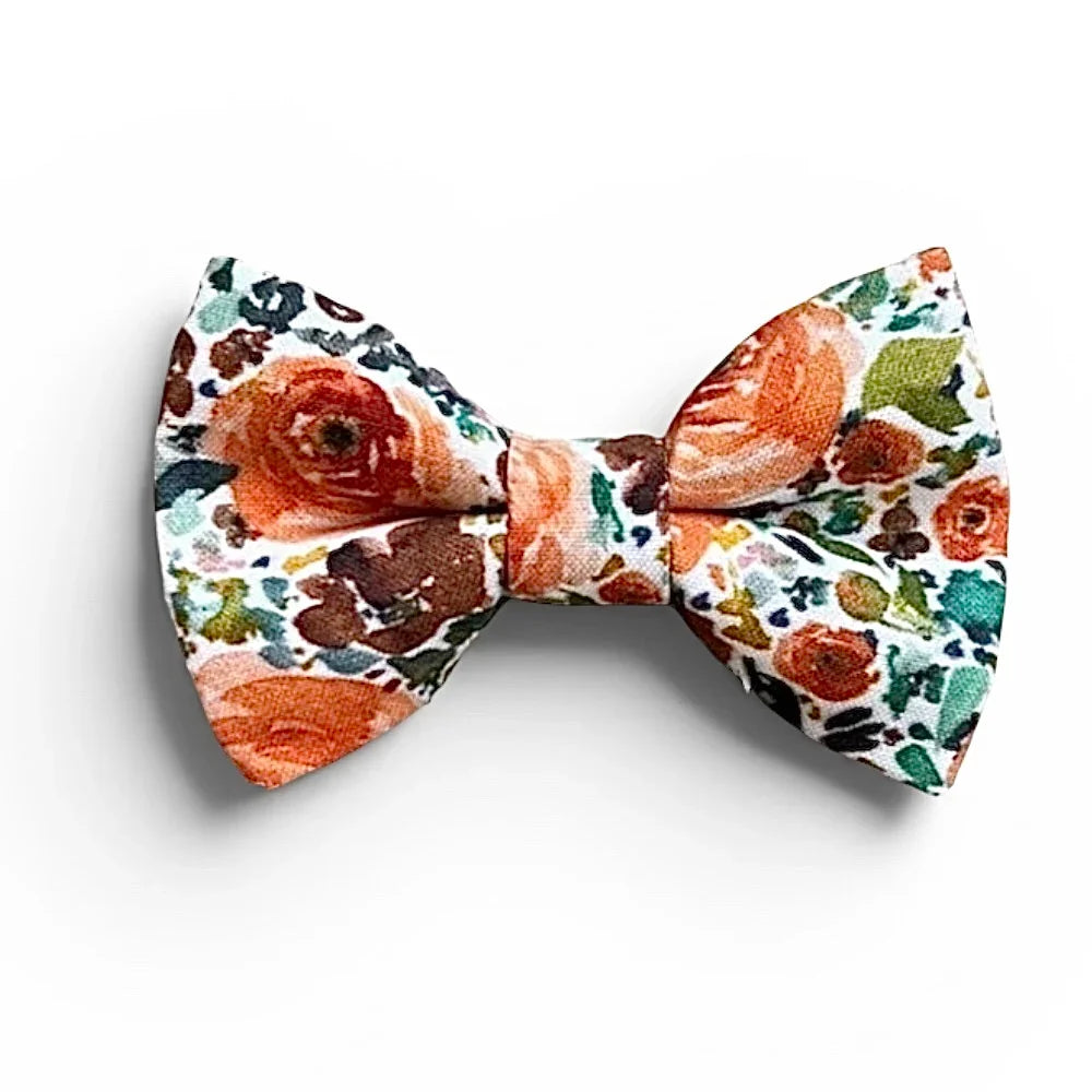 Promotional graphic from The Bold Bow Tie titled Let's Connect. On the left, a model with wavy blonde hair wears a white hair bow with a blue floral pattern. Circular text reads Handmade, 5-Star Rated, Premiere Customer Service. On the right, an Instagram icon prompts to follow @theboldbowtie and message for a coupon code. Below, an email icon encourages signing up for the VIP email list for the latest news and exclusive discounts, noting that the link to join is in the description.