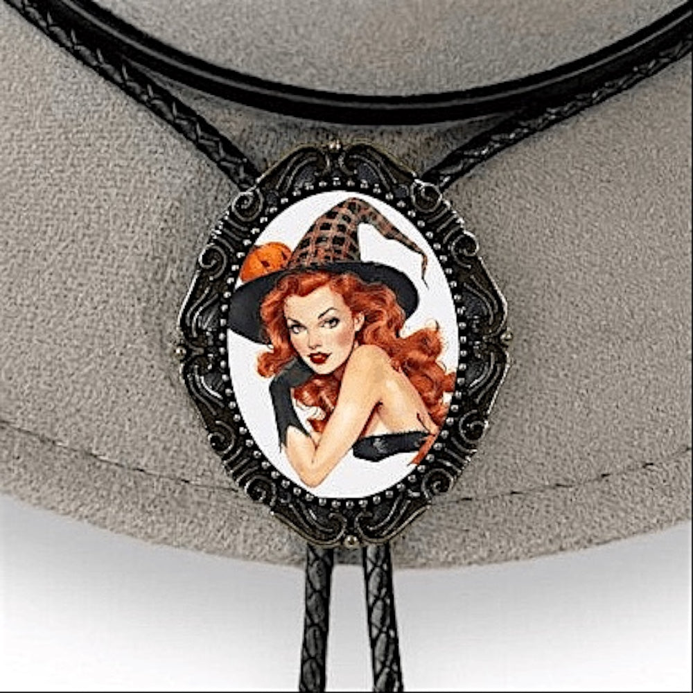 Bolo tie with a witch design on a gray background