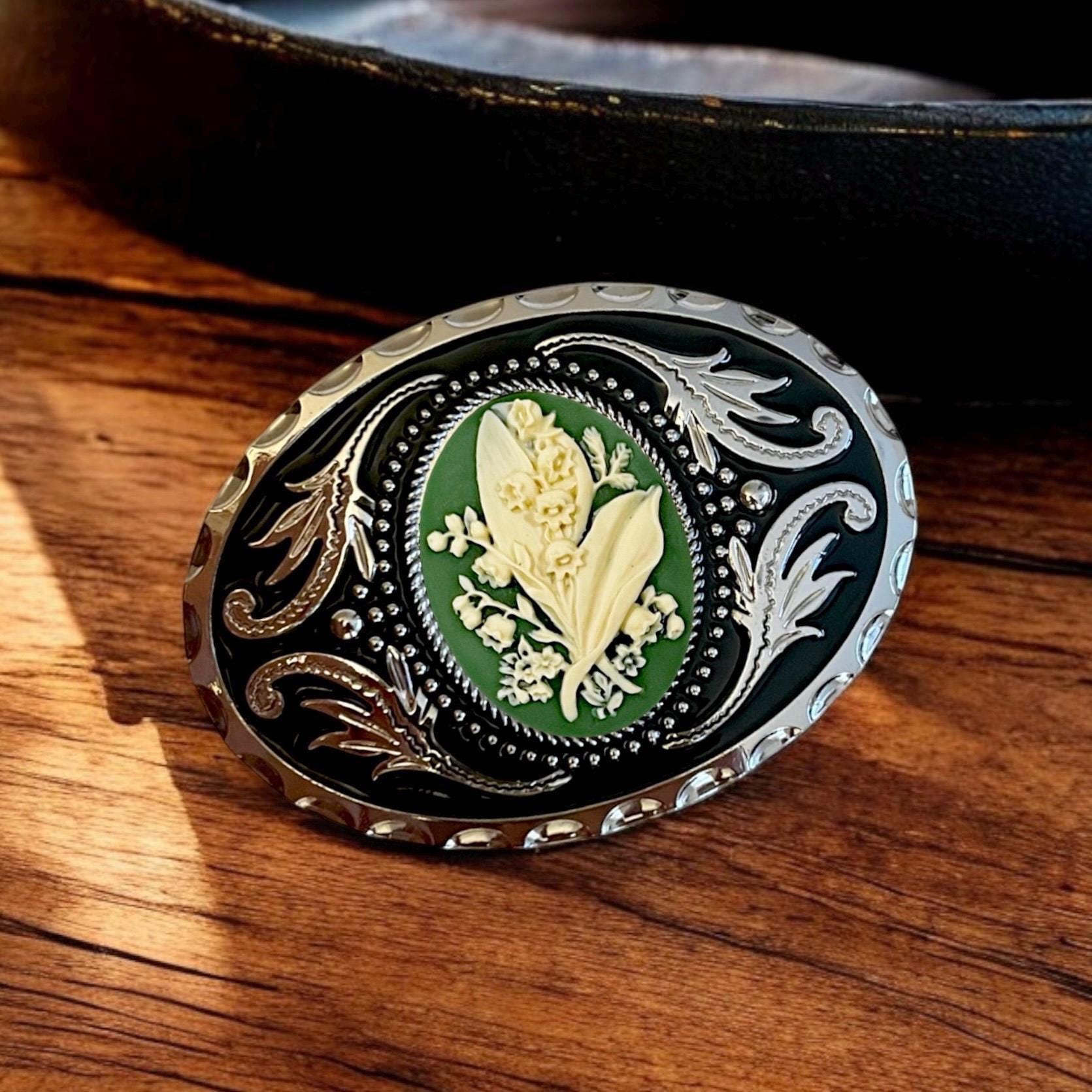 Belt Buckle Cowboy Accessory Lily of the Valley in Green beside a leather belt