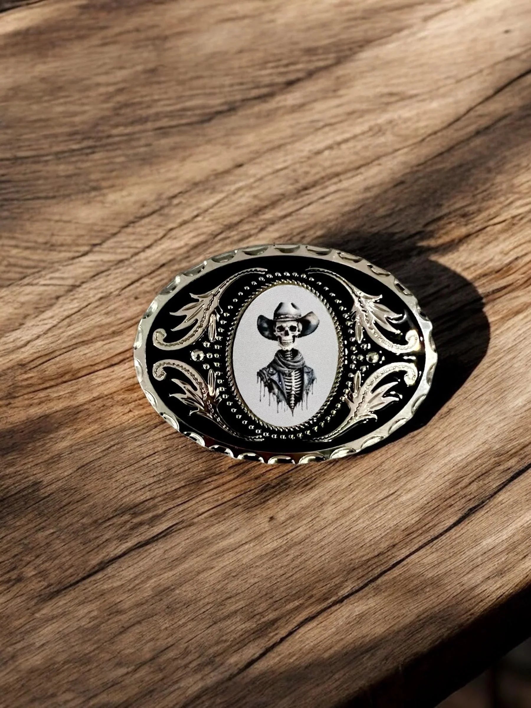 Two options for belt buckles: Option 1 has a leaf pattern and option 2 has flowers on it