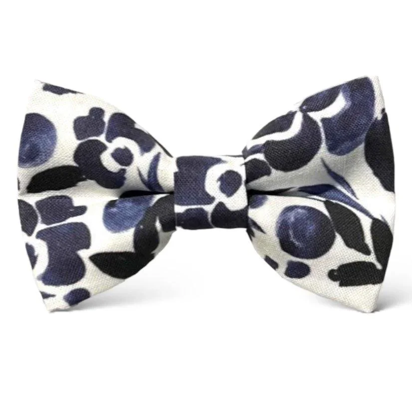 Navy and white floral patterned bow tie on a white background