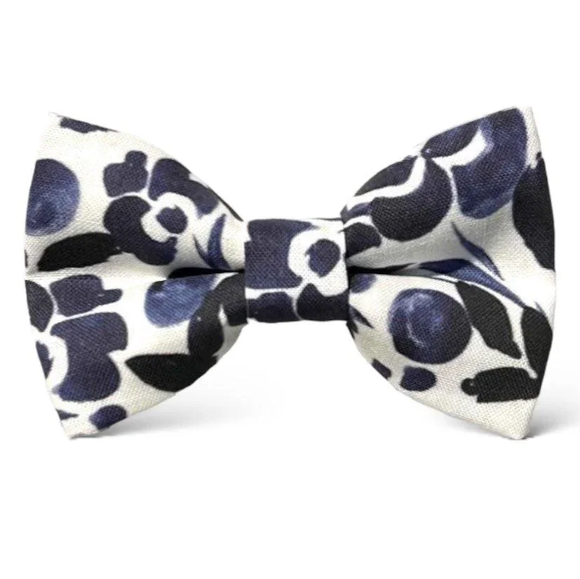 Navy and white floral patterned bow tie on a white background