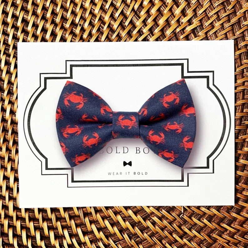 Dog bow tie size chart. Size Small is 3 1/2 inches wide for small dogs under 15 lbs. Size Medium is 4 inches wide for medium dogs between 15 band 40 lbs. Size Large is 4 1/2 inches wide for Large Dogs between 40 band 80 lbs. Size Extra Large is 5 1/2 inches wide for Extra Large Dogs over 80 lbs. Sizing is up to preference and pet bow ties slide on to dog collars with elastic.