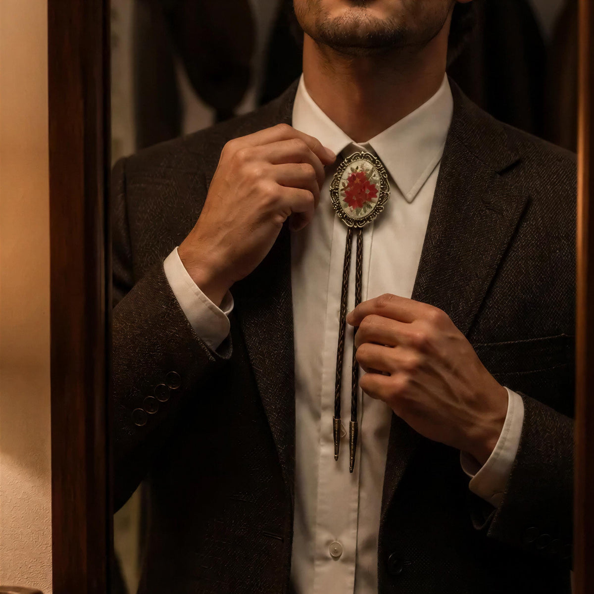 A unique winter wedding accessory for men: a red floral neckwear piece with poinsettia flowers, perfect as a thoughtful stocking stuffer gift for him.
