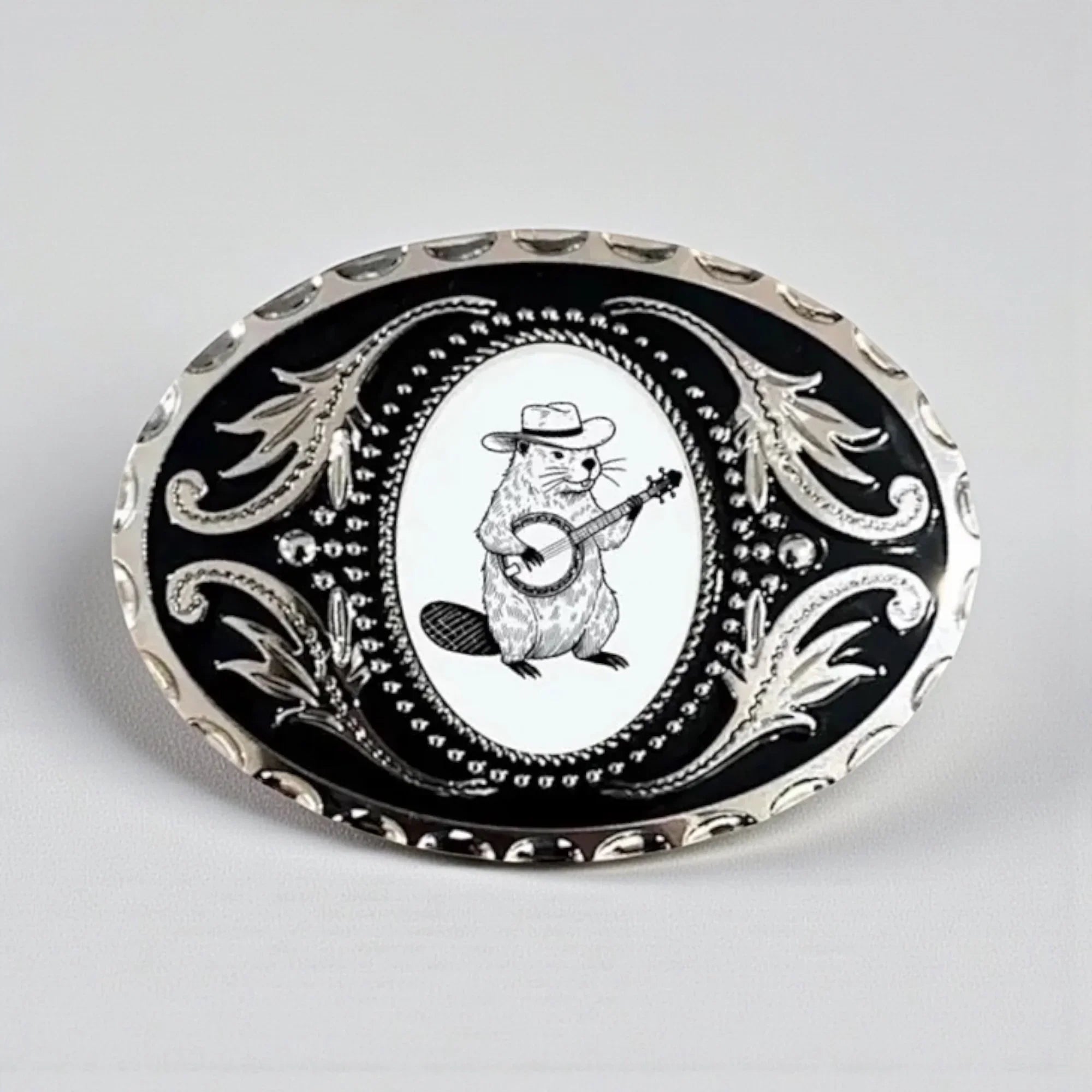 Beaver belt buckle with a beaver playing a banjo.