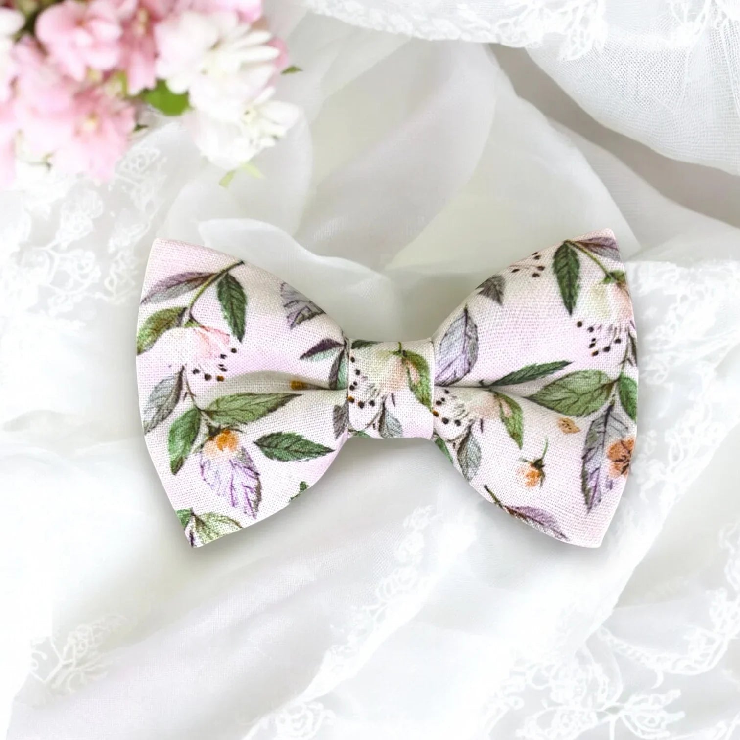 Size chart for pre-tied bow ties from The Bold Bow Tie detailing measurements across three sizes. Small is 3.5 inches wide and recommended for ages 6 months to 5 years. Medium is 4 inches wide and recommended for ages 6 to 12 years. Large is 4.5 inches wide and recommended for ages 13 years and up. Visual icons illustrate the relative sizes with horizontal arrows showing that width is measured from wingtip to wingtip. Bottom text notes that all bow ties are pre-tied and ready to add to your outfit.