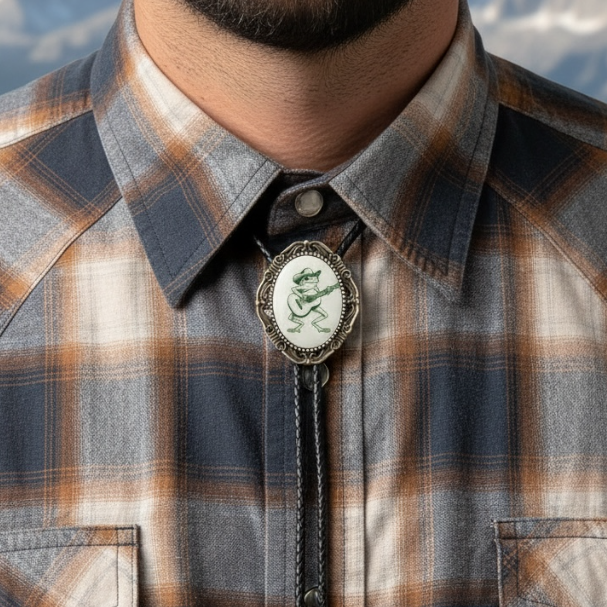 Plaid shirt with a decorative bolo tie featuring a frog design.