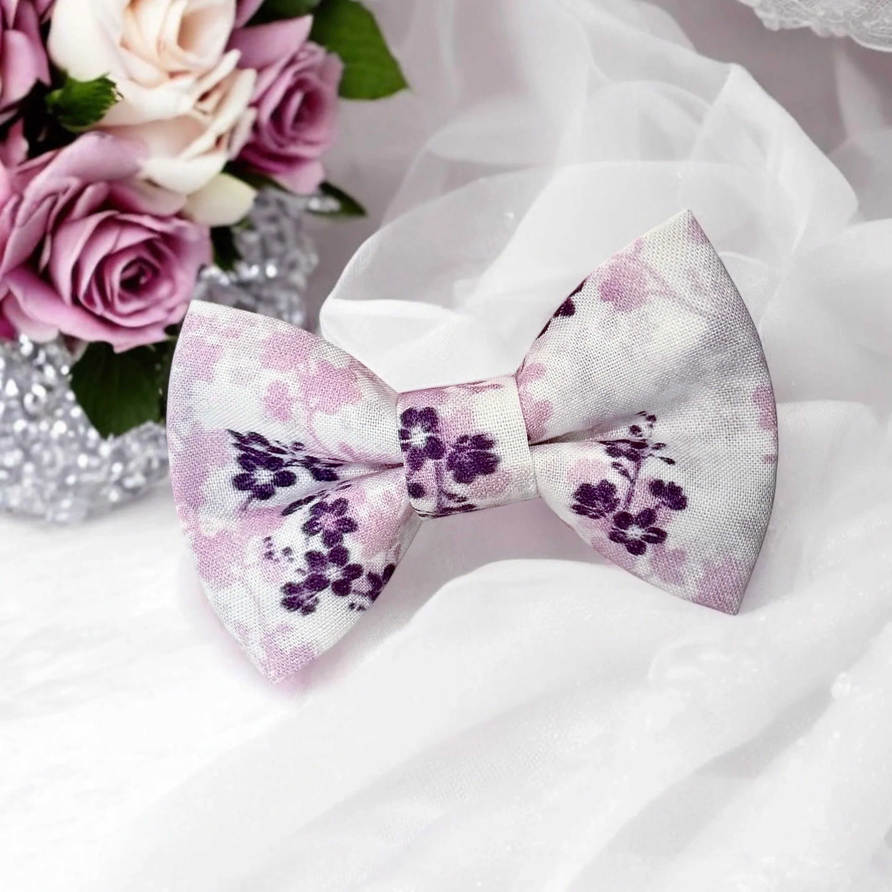 Size chart for pre-tied bow ties from The Bold Bow Tie detailing measurements across three sizes. Small is 3.5 inches wide and recommended for ages 6 months to 5 years. Medium is 4 inches wide and recommended for ages 6 to 12 years. Large is 4.5 inches wide and recommended for ages 13 years and up. Visual icons illustrate the relative sizes with horizontal arrows showing that width is measured from wingtip to wingtip. Bottom text notes that all bow ties are pre-tied and ready to add to your outfit.