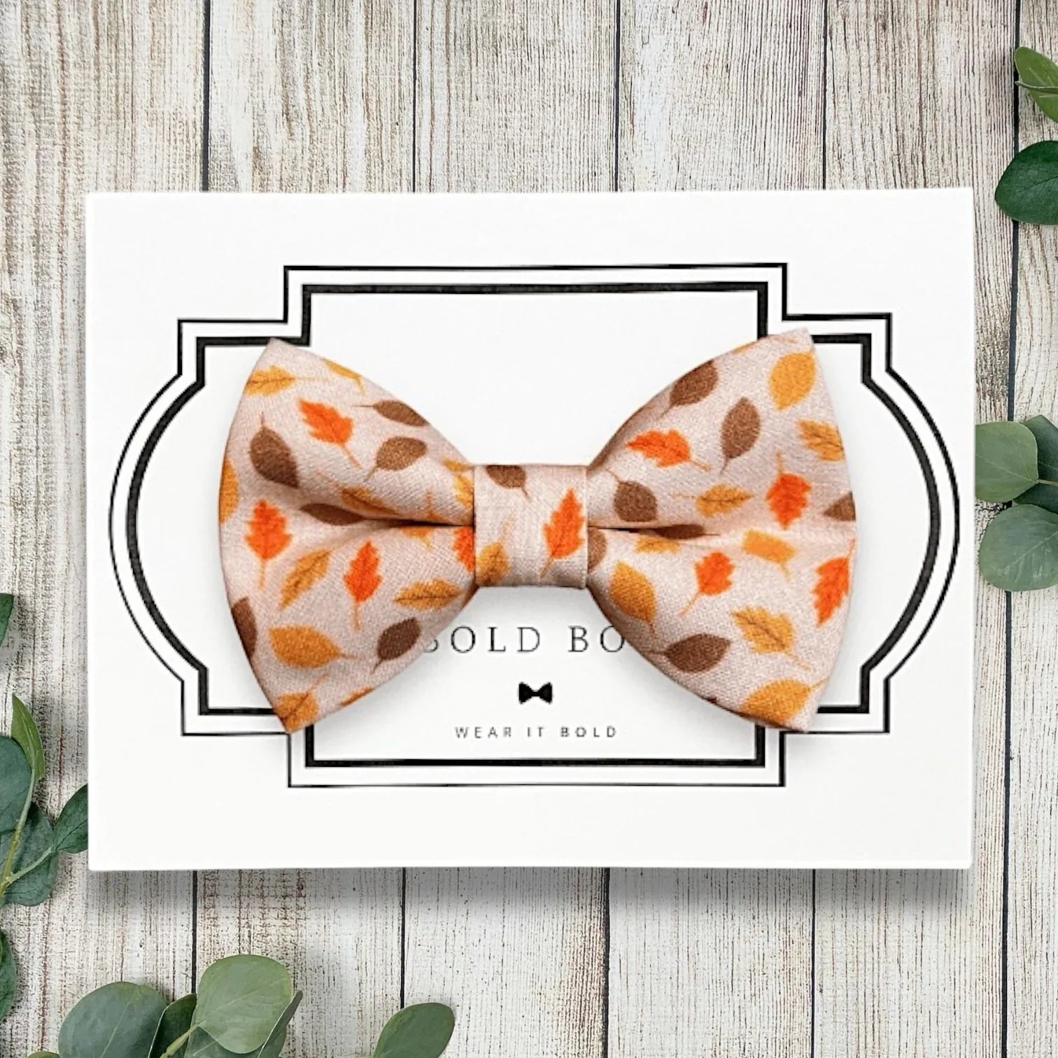Fall dog bow tie with orange leaves.