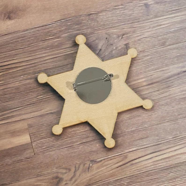 Wooden Ring Security Badge, with the name "Daniel" star-shaped, which is offered as an add-on to orders, if desired, for ring bearer badges. It says "ring security." Size 3 1/4 inches tall, easy pin style, perfect ring bearer gift idea.
