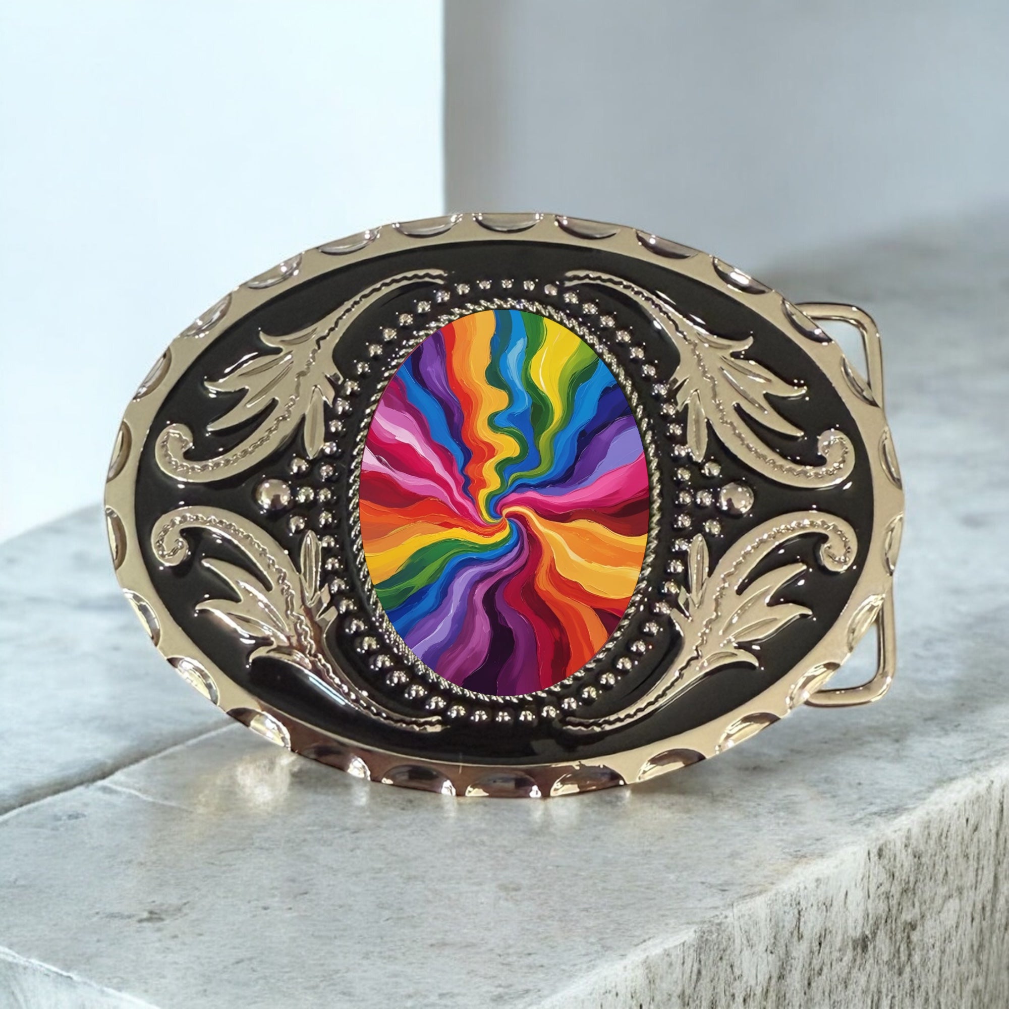 Belt buckle with rainbow design and gold detailing on a light gray surface
