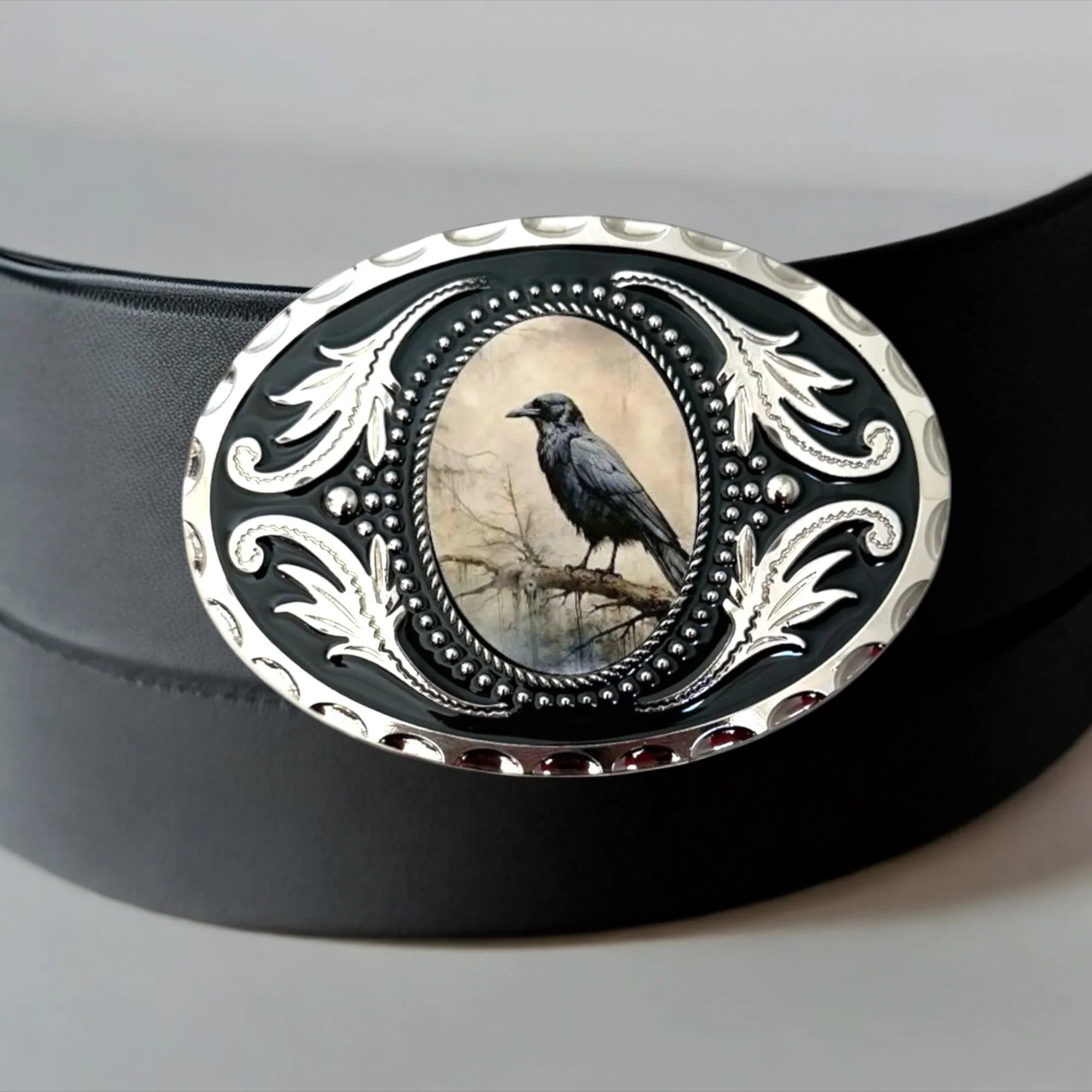 Black and Silver metal belt buckle featuring a crow