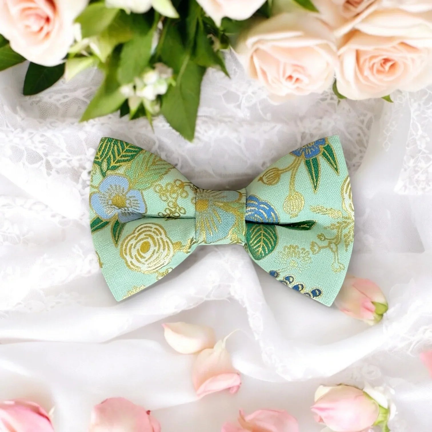 Size chart for pre-tied bow ties from The Bold Bow Tie detailing measurements across three sizes. Small is 3.5 inches wide and recommended for ages 6 months to 5 years. Medium is 4 inches wide and recommended for ages 6 to 12 years. Large is 4.5 inches wide and recommended for ages 13 years and up. Visual icons illustrate the relative sizes with horizontal arrows showing that width is measured from wingtip to wingtip. Bottom text notes that all bow ties are pre-tied and ready to add to your outfit.