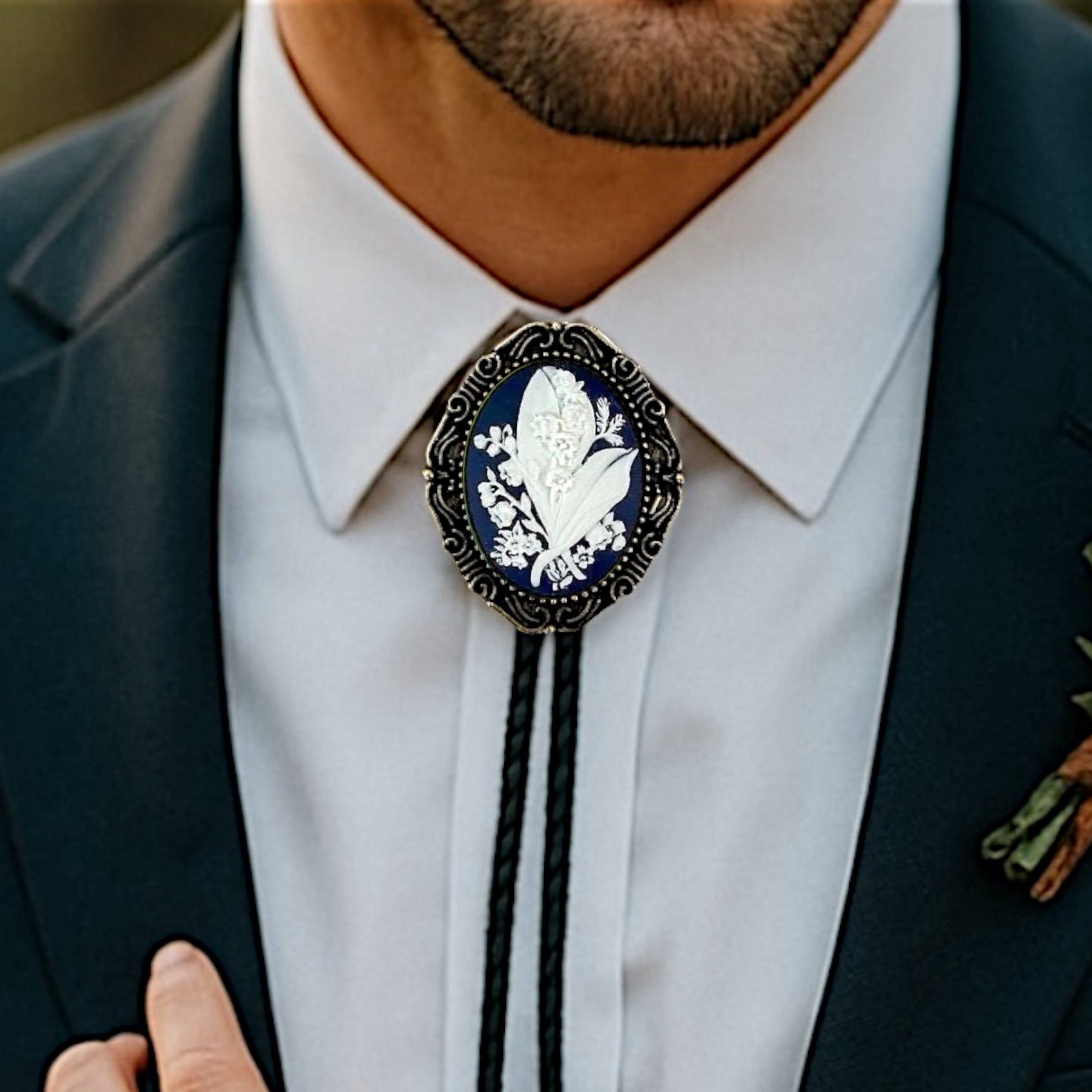 Man wearing a dark suit with a Navy Lily of the Valley Bolo Tie- Cowboy Tie Western String Tie featuring a white floral design.