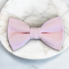 Pink bow tie on a marble surface