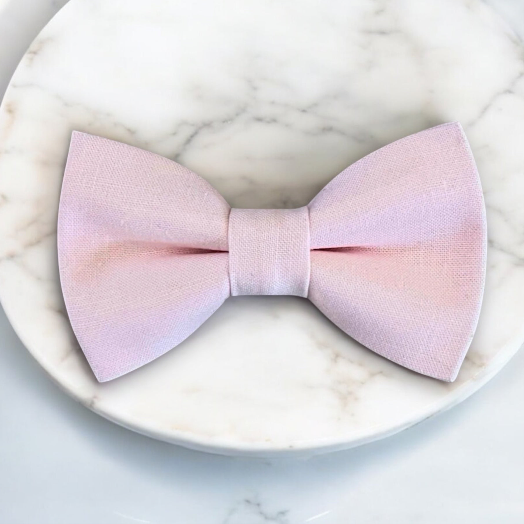 Pink bow tie on a marble surface