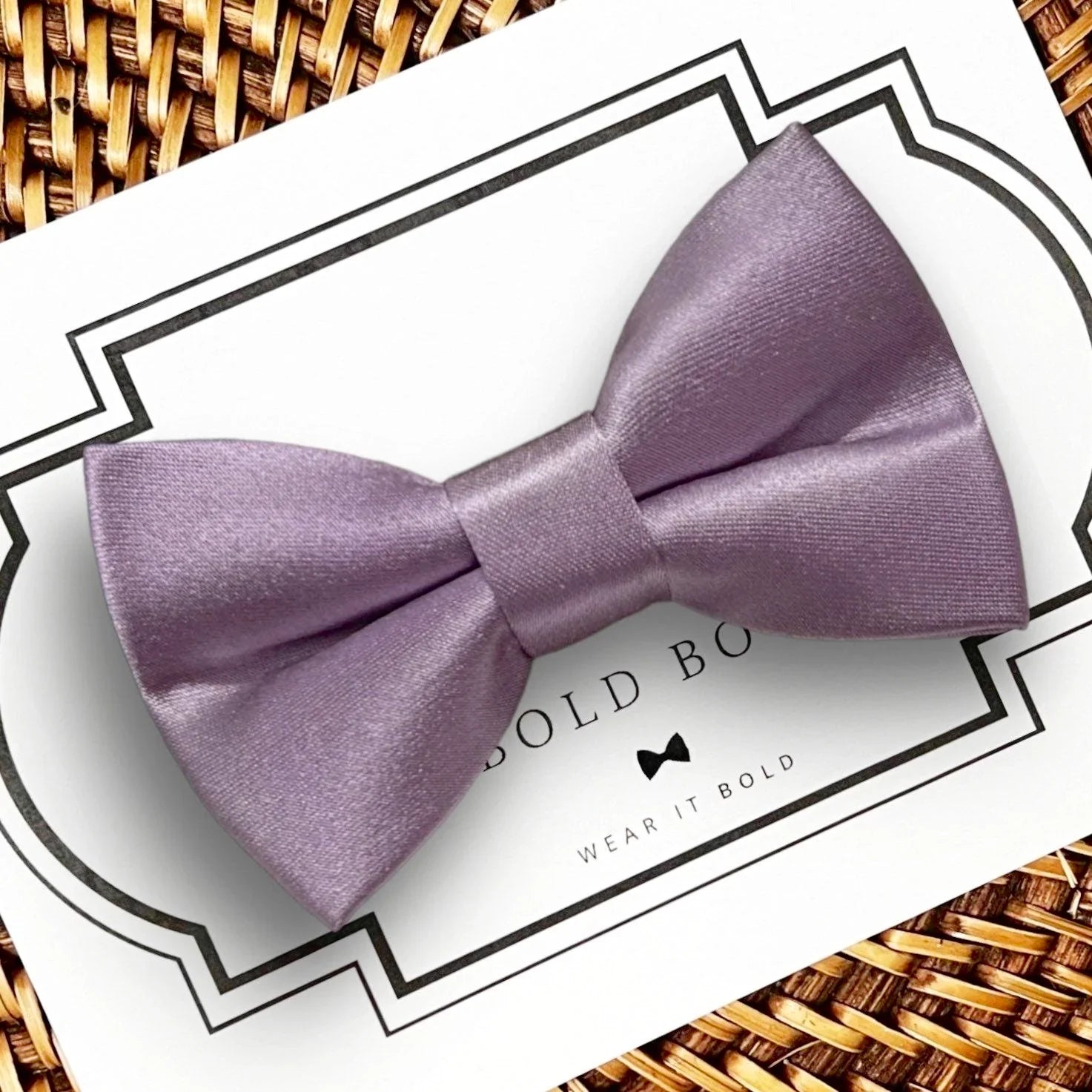Lavender satin bow for dog and cat collars displayed on a white card