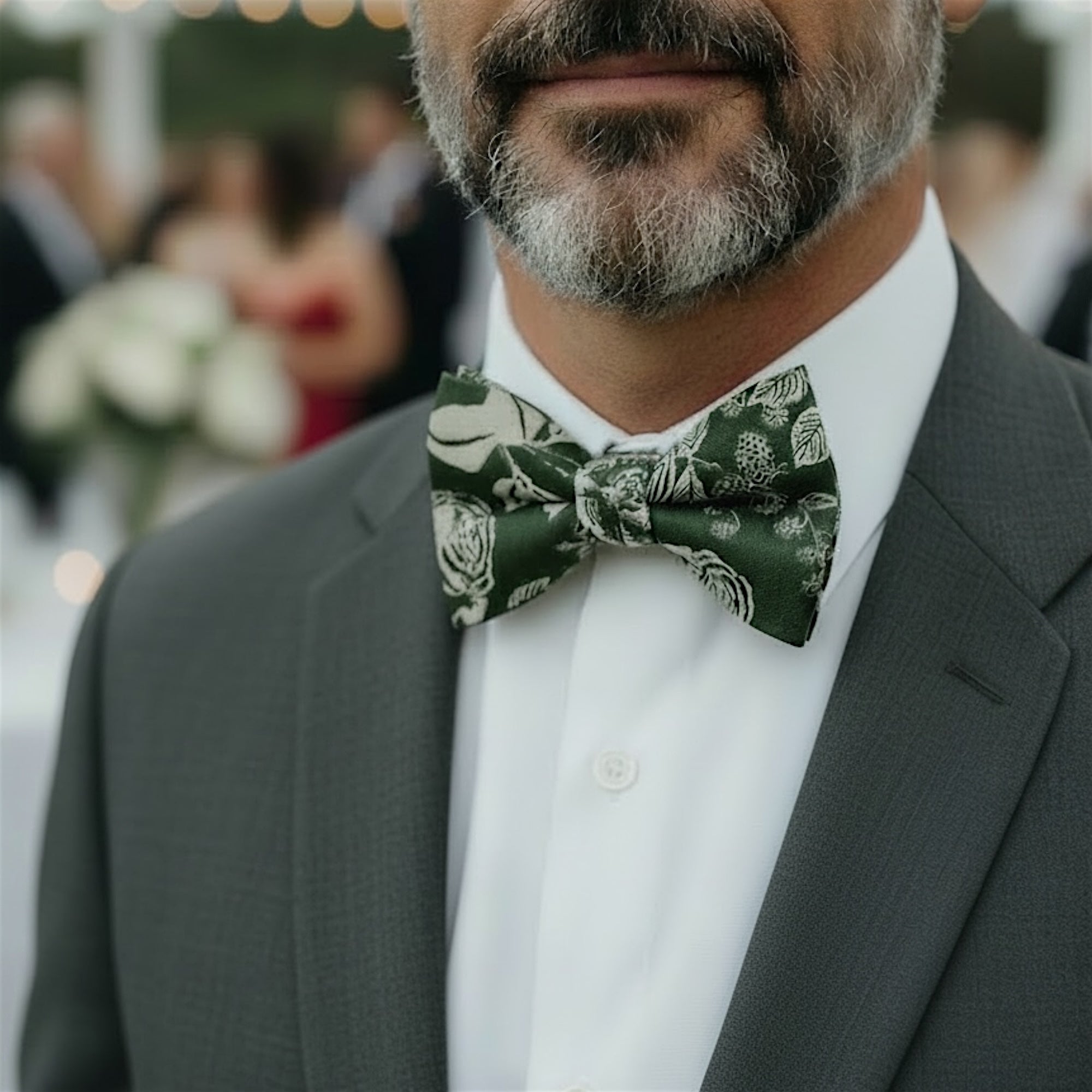 Groomsman wearing a gray suit and floral olive green bow tie at a wedding.