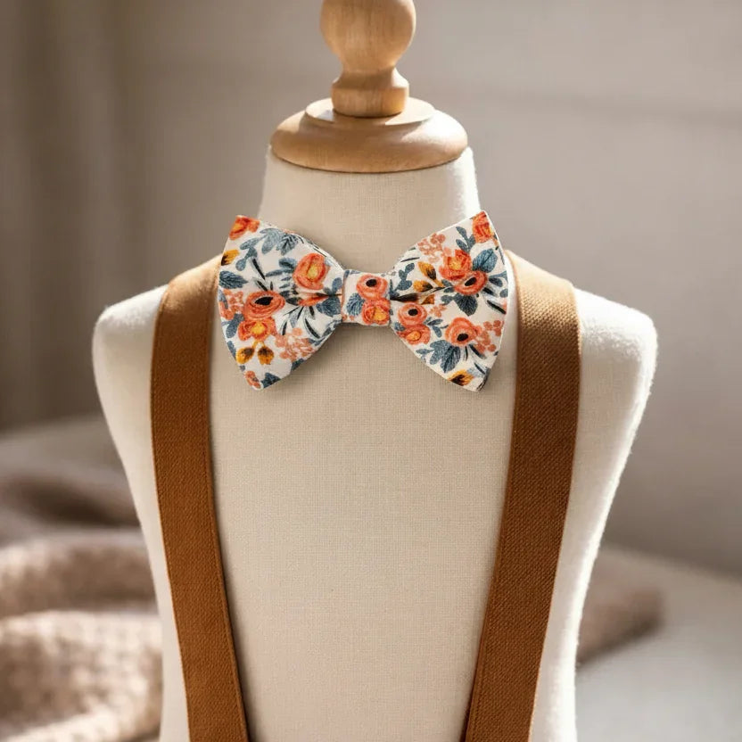 Size chart for pre-tied bow ties from The Bold Bow Tie detailing measurements across three sizes. Small is 3.5 inches wide and recommended for ages 6 months to 5 years. Medium is 4 inches wide and recommended for ages 6 to 12 years. Large is 4.5 inches wide and recommended for ages 13 years and up. Visual icons illustrate the relative sizes with horizontal arrows showing that width is measured from wingtip to wingtip. Bottom text notes that all bow ties are pre-tied and ready to add to your outfit.