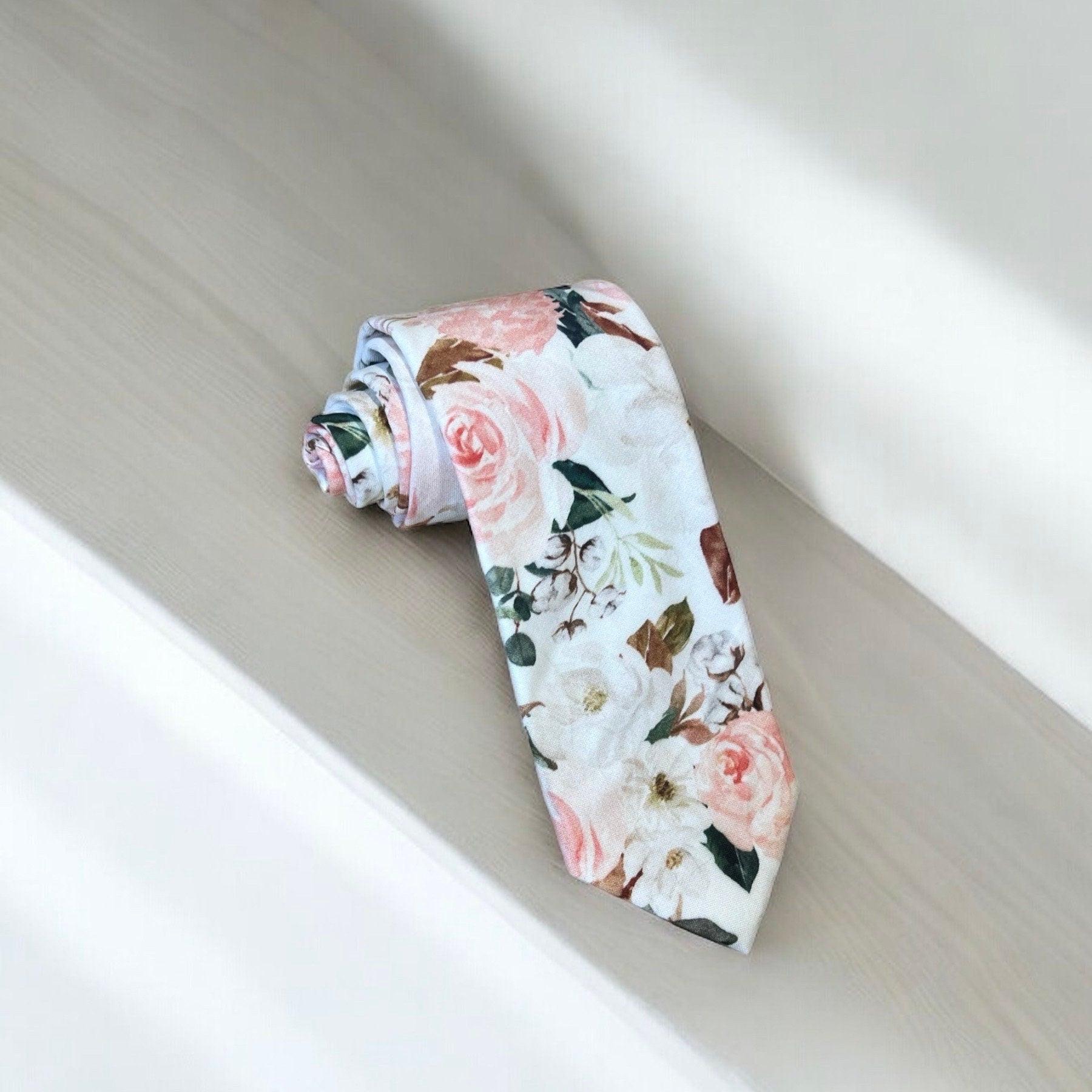 Blush and white floral men’s tie for wedding or special event.
