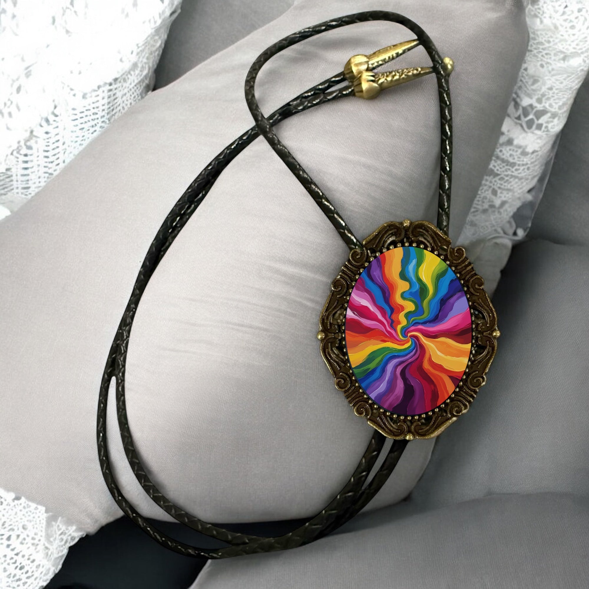 Bolo Tie with a rainbow colorful pendant on a white lace background