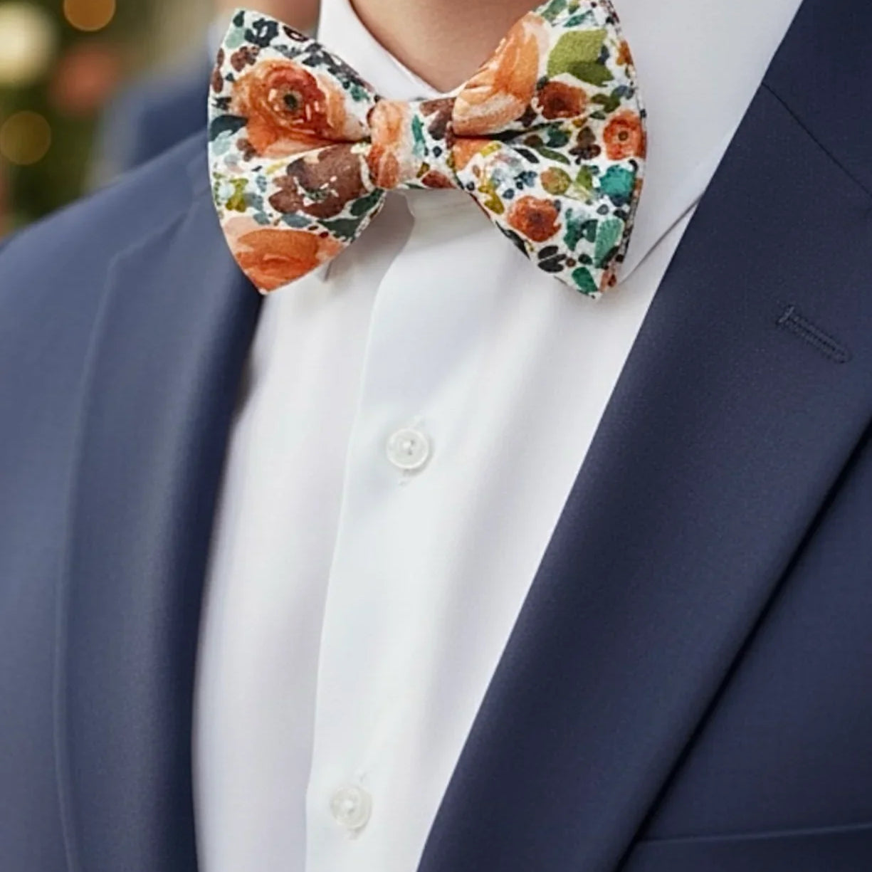 Size chart for pre-tied bow ties from The Bold Bow Tie detailing measurements across three sizes. Small is 3.5 inches wide and recommended for ages 6 months to 5 years. Medium is 4 inches wide and recommended for ages 6 to 12 years. Large is 4.5 inches wide and recommended for ages 13 years and up. Visual icons illustrate the relative sizes with horizontal arrows showing that width is measured from wingtip to wingtip. Bottom text notes that all bow ties are pre-tied and ready to add to your outfit.