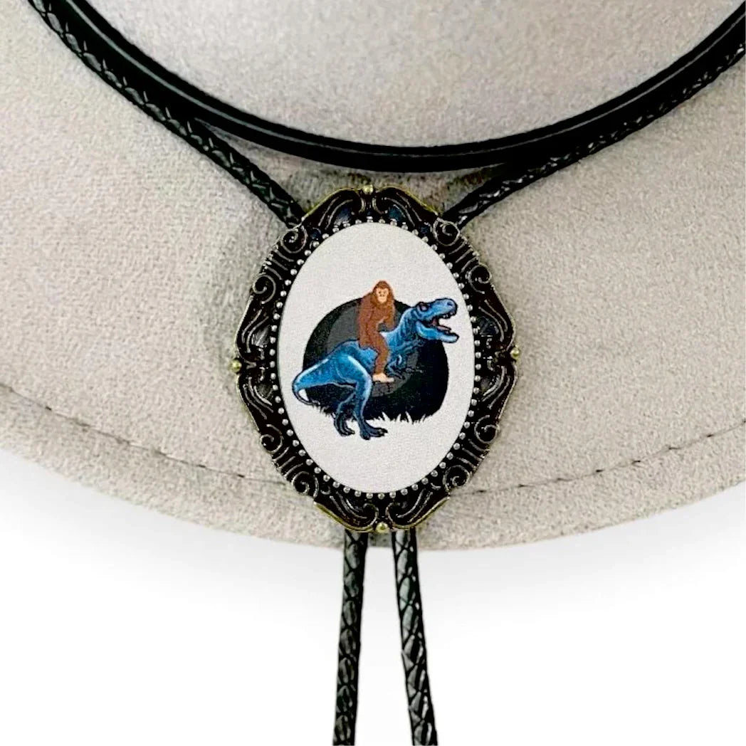 Bigfoot riding a Dinosaur Bolo tie for men groomsmen and wedding.