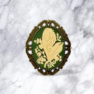 Decorative brooch with floral design on a marble background